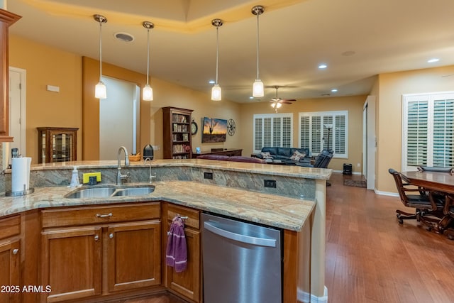20506 N 271st Ave, Buckeye, AZ 85396 - kitchen featuring a sink, dishwasher, brown cabinetry, a ceiling fan, and wood finished floors