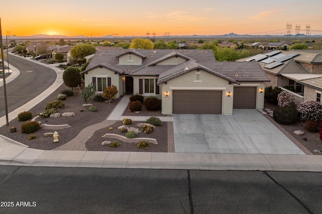 20506 N 271st Ave, Buckeye, AZ 85396 - view of front of house featuring an attached garage, driveway, a mountain view, and stucco siding