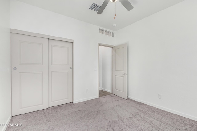 unfurnished bedroom with carpet floors, a closet, visible vents, and baseboards