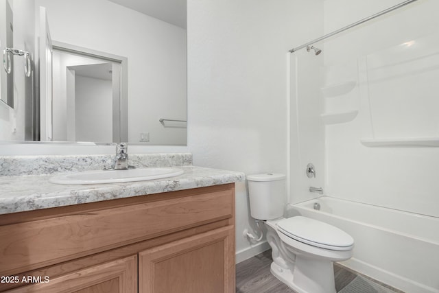 full bathroom featuring bathtub / shower combination, vanity, and toilet