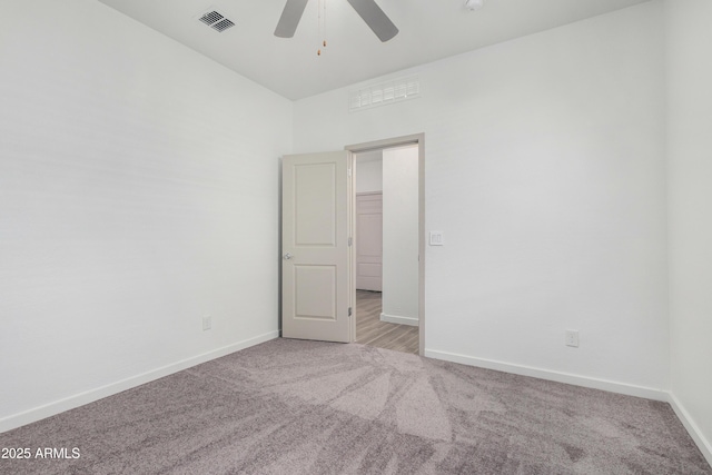 unfurnished room featuring baseboards, ceiling fan, visible vents, and light colored carpet