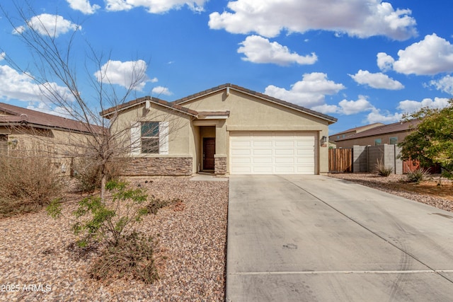 ranch-style house with driveway, stone siding, an attached garage, fence, and stucco siding