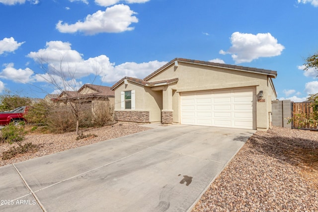 ranch-style house featuring a garage, fence, concrete driveway, stone siding, and stucco siding