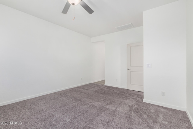 unfurnished room with carpet floors, visible vents, ceiling fan, and baseboards