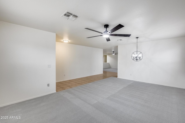 empty room with visible vents, baseboards, carpet flooring, and a ceiling fan