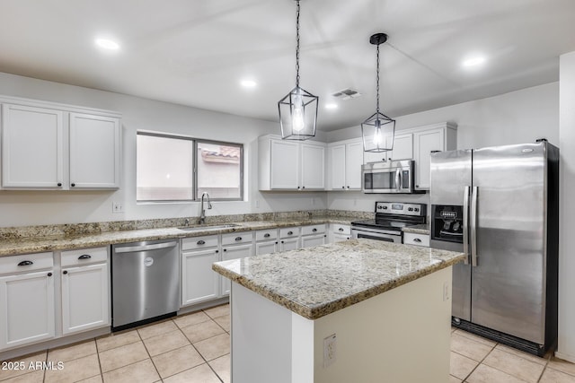 kitchen featuring visible vents, a sink, stainless steel appliances, white cabinets, and light tile patterned floors