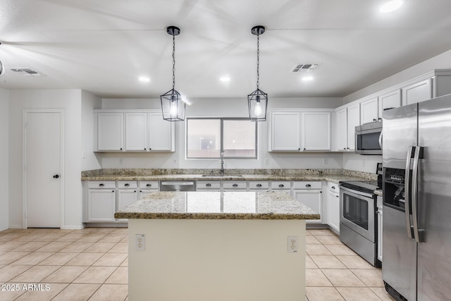 kitchen featuring light tile patterned floors, visible vents, a sink, stainless steel appliances, and a center island