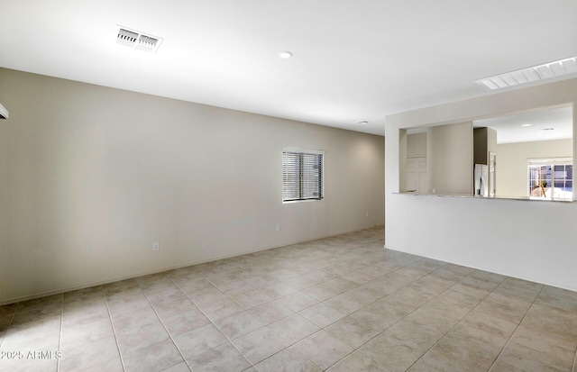 empty room featuring light tile patterned flooring, visible vents, and recessed lighting