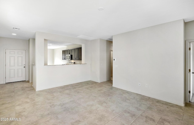 unfurnished living room featuring visible vents
