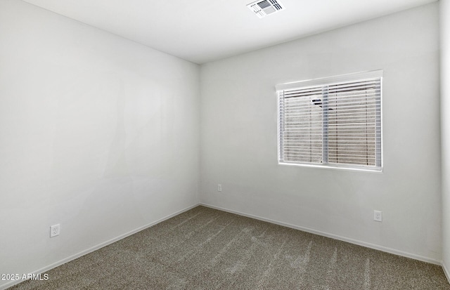 spare room featuring visible vents, carpet flooring, and baseboards