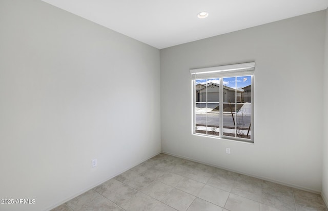 empty room featuring recessed lighting and light tile patterned floors