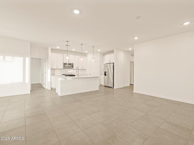 unfurnished living room featuring light tile patterned floors and sink