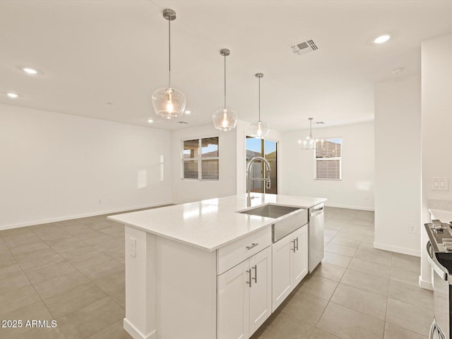 kitchen featuring hanging light fixtures, sink, a kitchen island with sink, and appliances with stainless steel finishes