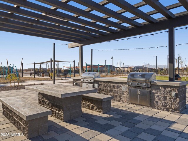 view of patio / terrace with a pergola and area for grilling