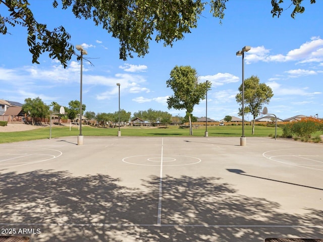 view of basketball court with a yard