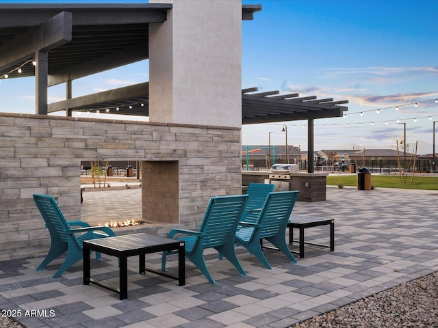 patio terrace at dusk featuring area for grilling and grilling area