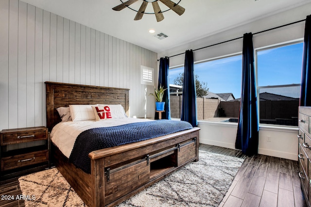 bedroom with ceiling fan and dark wood-type flooring