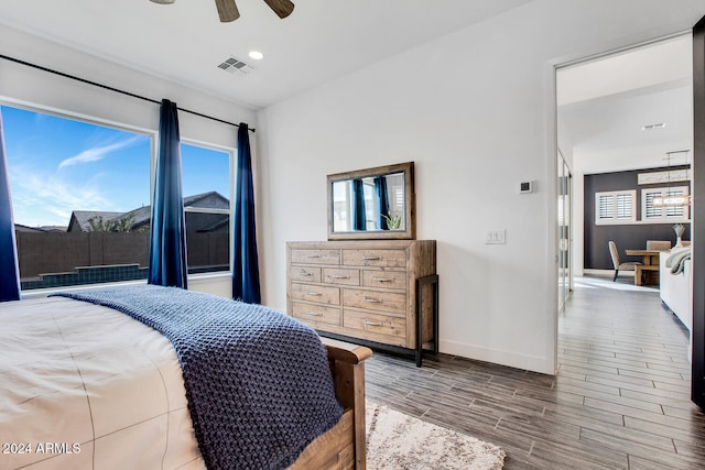 bedroom with hardwood / wood-style floors and ceiling fan