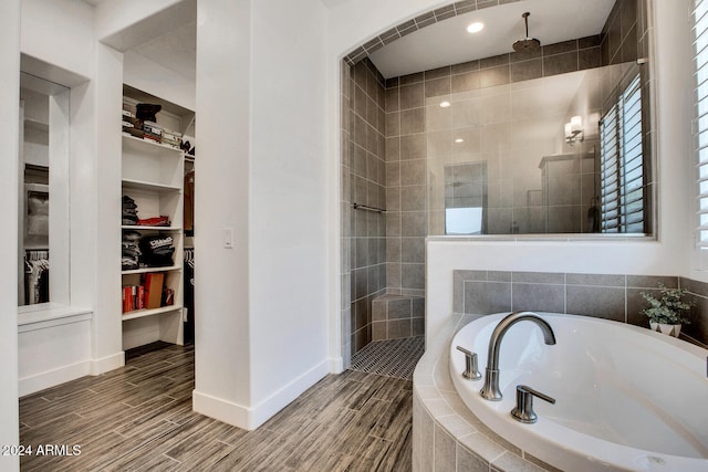 bathroom featuring shower with separate bathtub