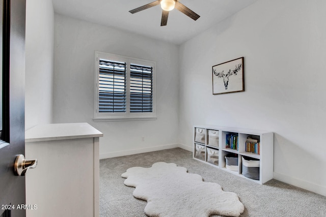 interior space with light colored carpet and ceiling fan