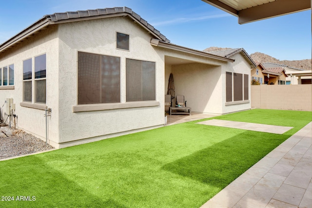 rear view of property with a yard and a patio