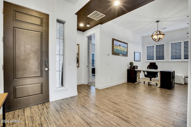 entryway with a notable chandelier and light wood-type flooring