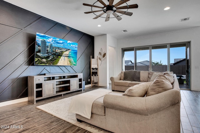 living room featuring ceiling fan and hardwood / wood-style floors