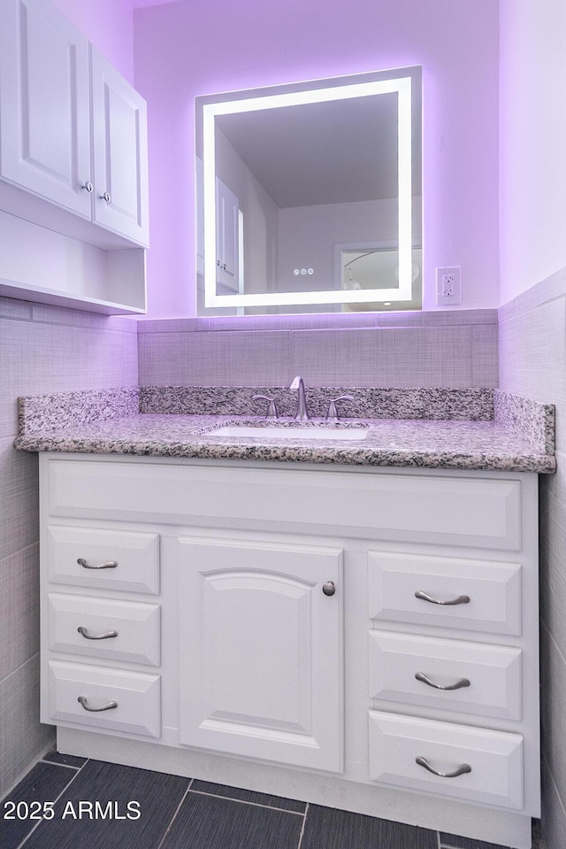 bathroom with tile patterned flooring and vanity