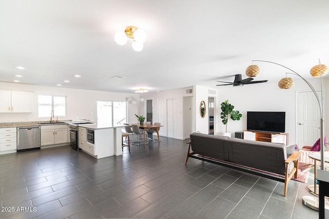 living room featuring ceiling fan, visible vents, and recessed lighting