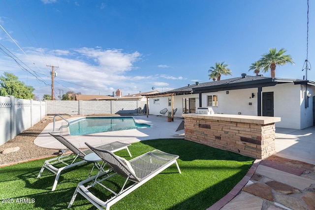 view of swimming pool featuring a patio area, an outdoor bar, and a yard