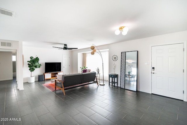 tiled living room with ceiling fan