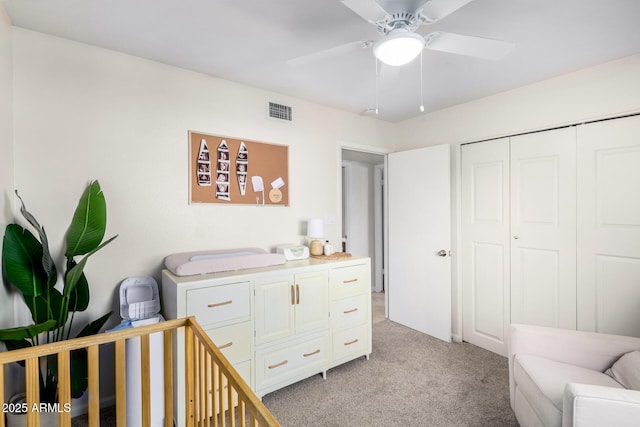 carpeted bedroom featuring a closet and ceiling fan