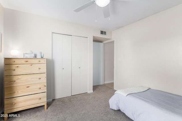 bedroom with a closet, ceiling fan, and carpet