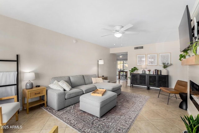 living room featuring ceiling fan and light tile patterned floors