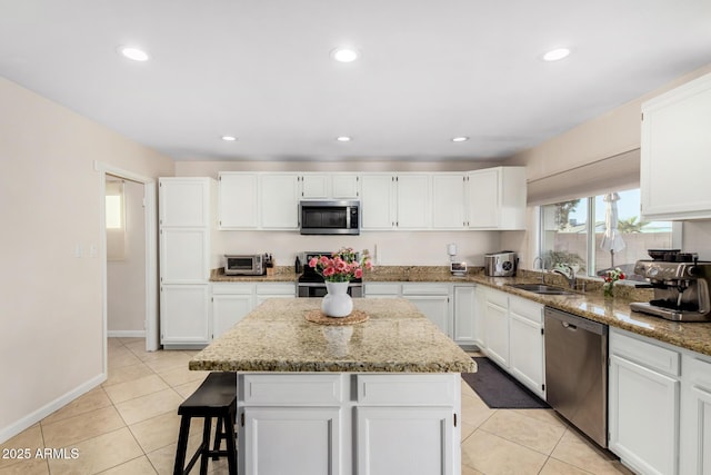 kitchen featuring appliances with stainless steel finishes, sink, and white cabinets