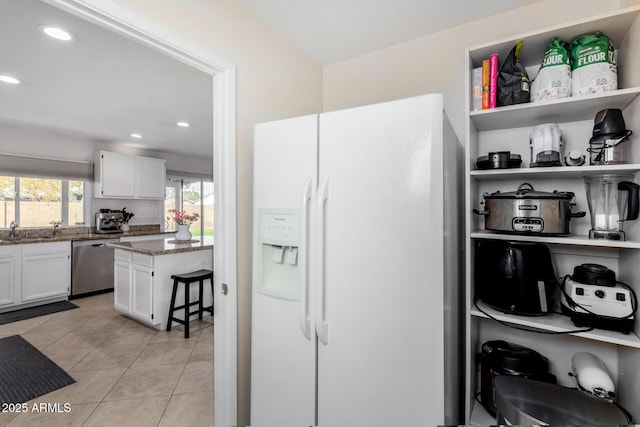 kitchen with dishwasher, sink, white cabinets, dark stone counters, and white fridge with ice dispenser