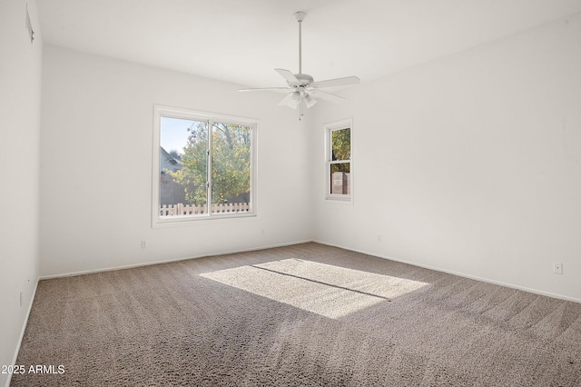 carpeted spare room featuring ceiling fan