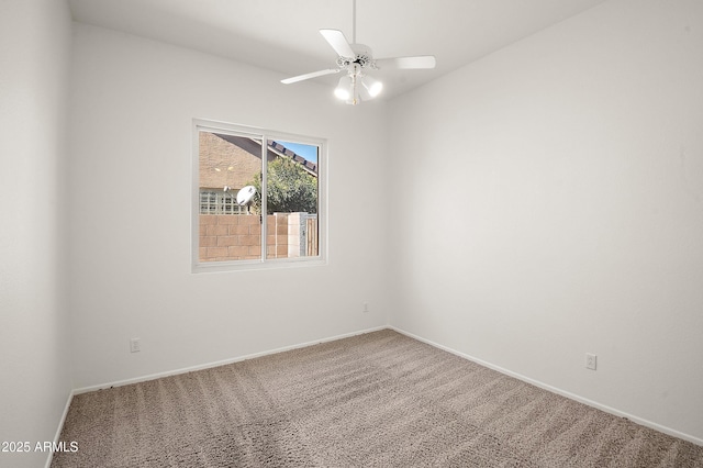 unfurnished room featuring ceiling fan and carpet