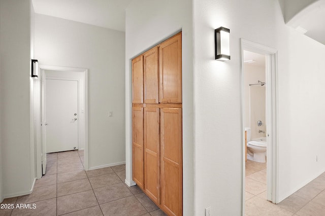 hallway with light tile patterned floors