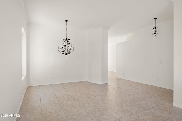 tiled empty room featuring ornamental molding and a chandelier