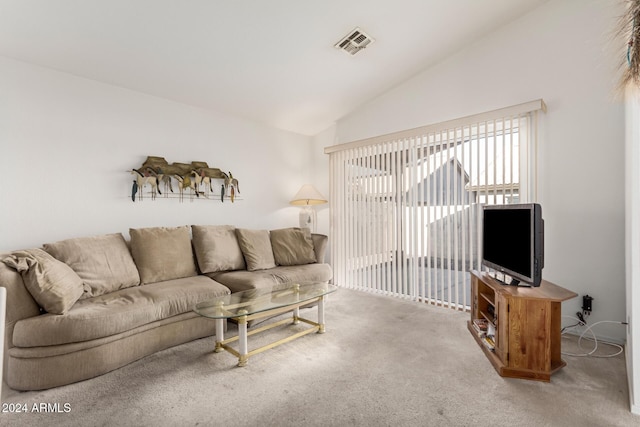 carpeted living room featuring vaulted ceiling