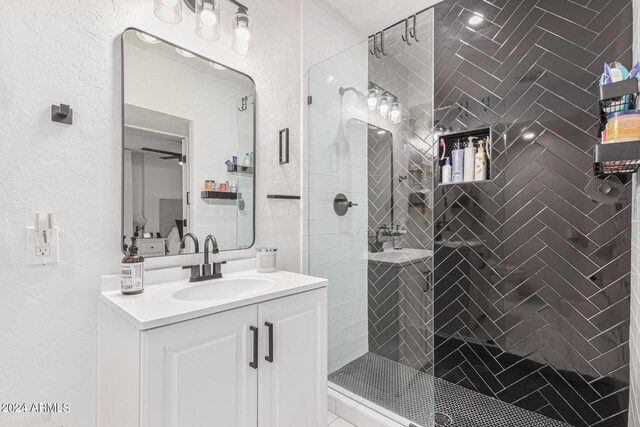 bathroom featuring walk in shower and vanity