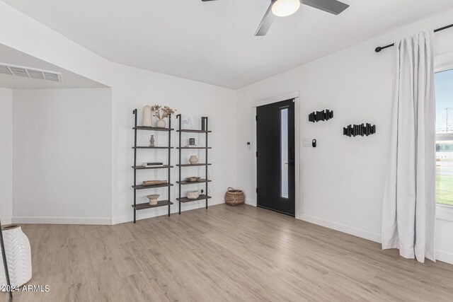 unfurnished room featuring ceiling fan and light wood-type flooring