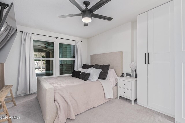 bedroom with light carpet and ceiling fan