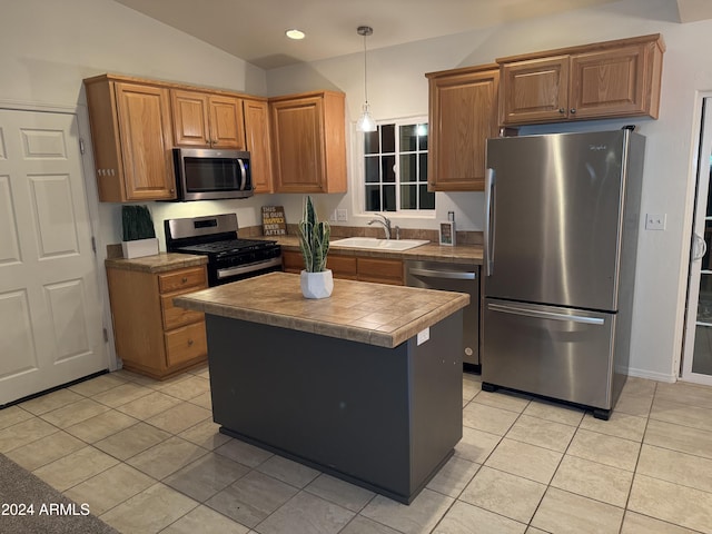 kitchen featuring stainless steel appliances, sink, tile countertops, a kitchen island, and lofted ceiling