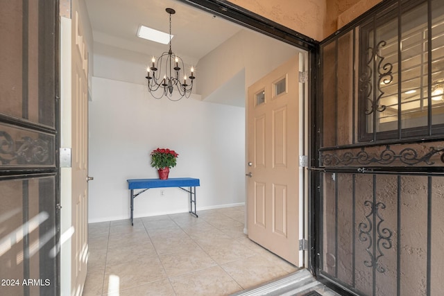 foyer entrance with an inviting chandelier and light tile patterned flooring