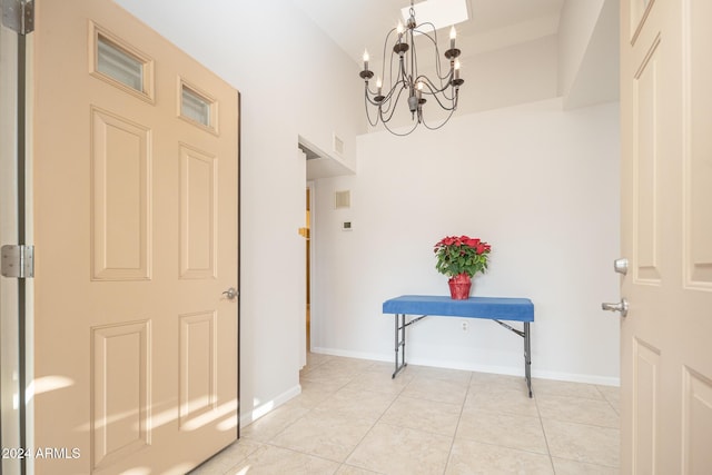 hallway featuring light tile patterned flooring and a chandelier