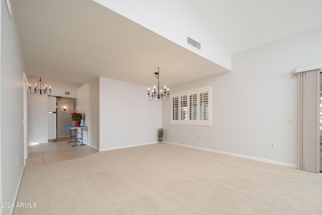 unfurnished room with a chandelier, light carpet, plenty of natural light, and lofted ceiling