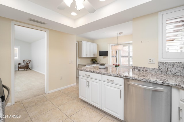 kitchen with stainless steel dishwasher, a healthy amount of sunlight, white cabinets, and pendant lighting