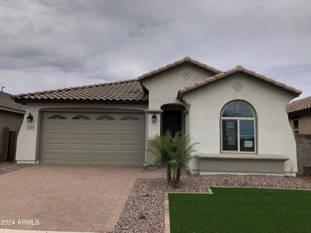 mediterranean / spanish-style home featuring a garage